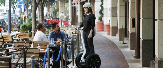 Three people riding their Segway HTs in a park.