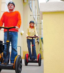 Two people riding their Segway HTs.